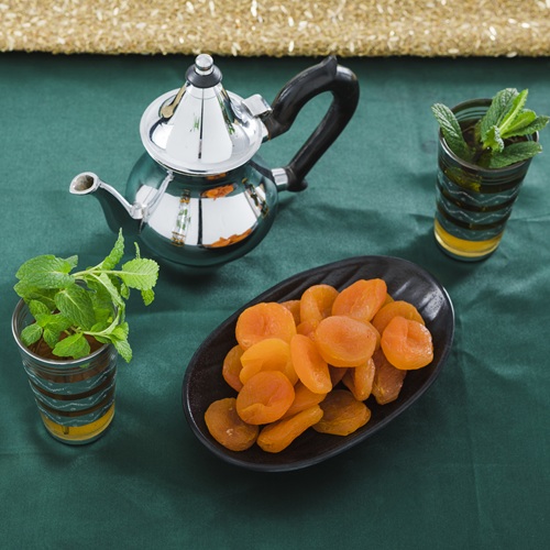 cups drink near teapot dried apricots
