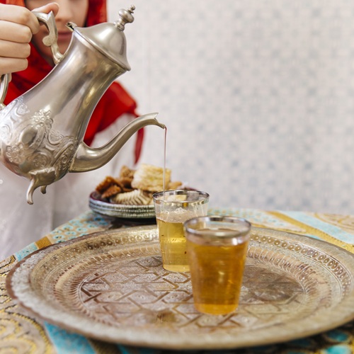 muslim woman pouring tea